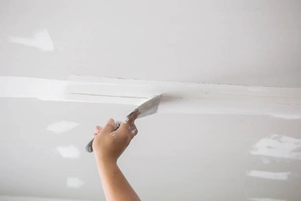 hand drywall painting on top ceiling with white ceiling -drywall repair